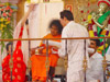 Bhagawan viewing the charts containing auspicious letters and symbols