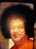 Sai Miracle photo Red Sindhur and Vibhuti appeared on Sri Sathya Sai Baba's photo during Durga Pooja in Sai devotees pooja room in New Delhi.