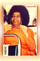 bhagawan-sri-sathya-baba-holding-his-sun-glasses-smiling-on-a-bus-photo